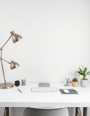 Front view of minimalistic workplace with blank white wall, computer, coffee cup and other items....