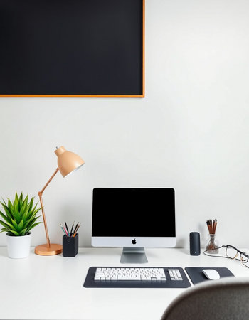 Workplace with computer, keyboard, glasses and plant on white table