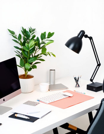 Workplace with computer, laptop, stationery and plant in officeの写真素材