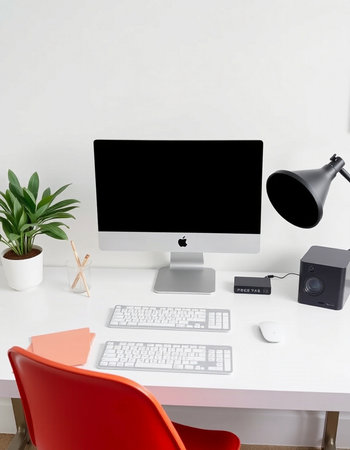 workplace with computer, mouse, keyboard, lamp and plant on table