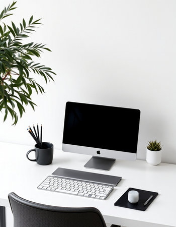 Front view of modern workspace with blank computer monitor, stationery and plant on white table....