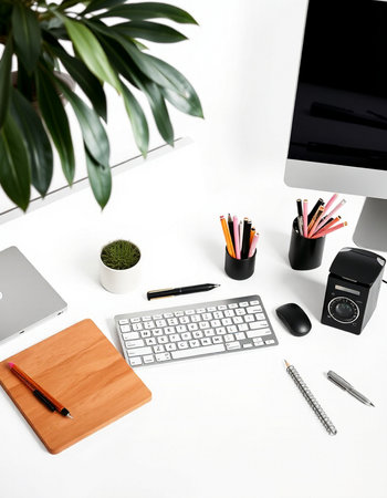 White office desk with computer, supplies and plant. Flat lay, top view