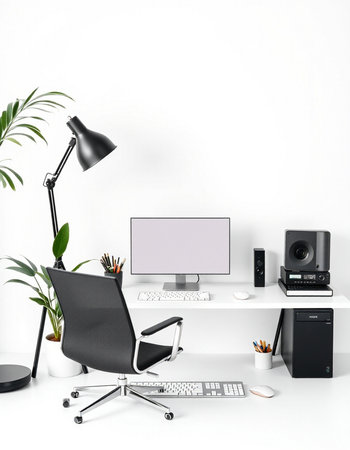 Workplace with computer, keyboard, mouse, lamp, coffee cup and plant.
