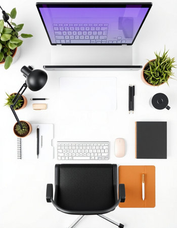 Top view of modern workplace with laptop, stationery and office supplies on white backgroundの写真素材