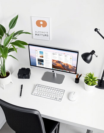 Workplace with computer and stationery on white table.