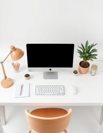 workplace with computer, keyboard, coffee cup, plant and lamp