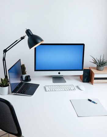workplace with computer, lamp and other items.