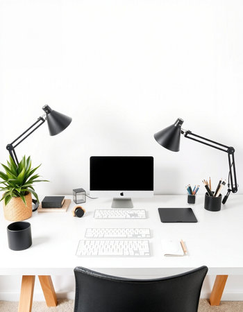 Minimalistic workplace with computer, supplies and stationery on white tableの写真素材