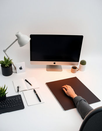 High angle view of person working with computer at desk in officeの写真素材
