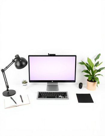 Modern workspace with blank screen computer, stationery and plant on white background