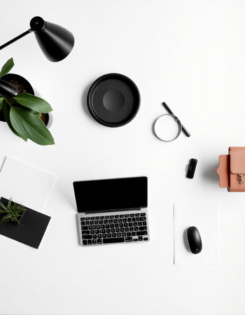 Top view of modern workplace with laptop, stationery and plant on white background