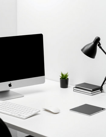workplace with computer, lamp and tablet on white table in office