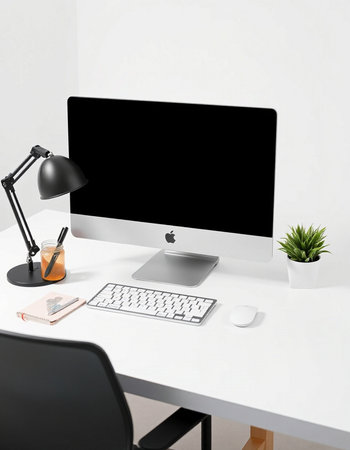 Workplace with computer, lamp and stationery on table in office