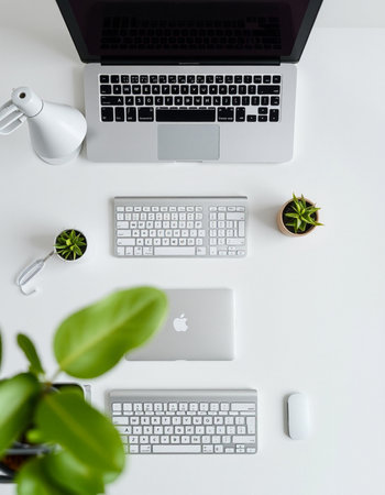 White office desk table with laptop computer, coffee cup and succulent plant. Top view with copy...