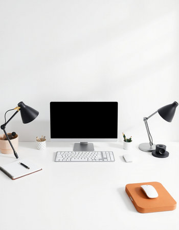 workplace with computer, lamp and stationery on table in office