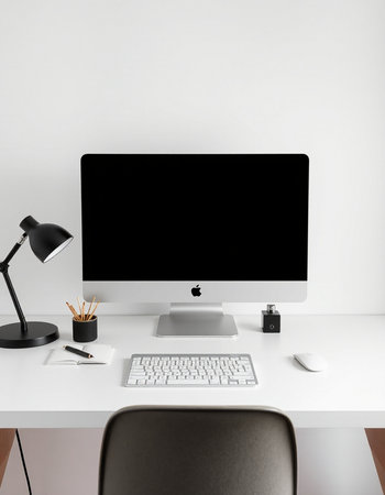Minimalistic workplace with computer, keyboard, mouse and stationery on table