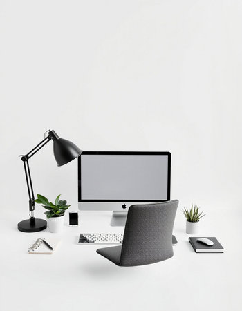 Modern workspace with computer, supplies and coffee cup isolated on white backgroundの写真素材
