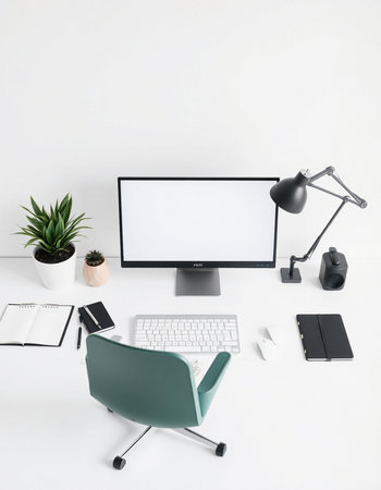 Modern workplace with computer, stationery and copy space on white wall backgroundの写真素材
