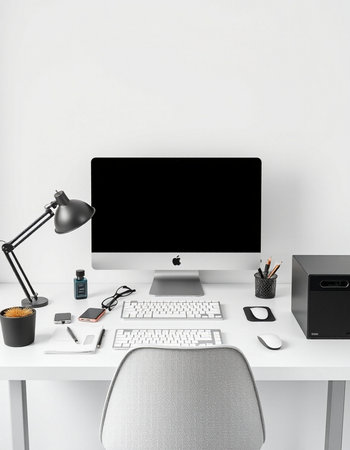 Workplace with computer, keyboard, mouse, lamp and other items on white tableの写真素材