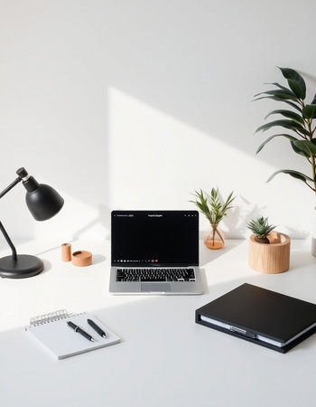 workplace with laptop, notebook, stationery and houseplantsの写真素材