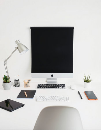 Minimalistic workplace with computer, supplies and coffee cup on white table