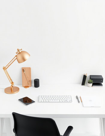 workplace with computer, lamp and stationery on white wall backgroundの写真素材