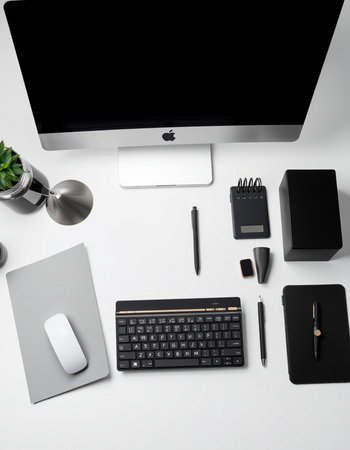 White office desk with computer, keyboard, mouse, notebook and pen.の写真素材