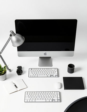 Modern workspace with computer, keyboard, mouse, notebook, lamp and coffee cup on white backgroundの写真素材