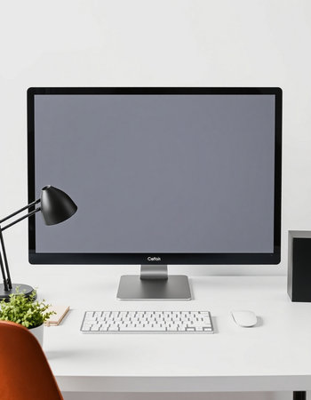 Close up of modern designer desktop with empty computer screen, keyboard, mouse and coffee cup. Mock...