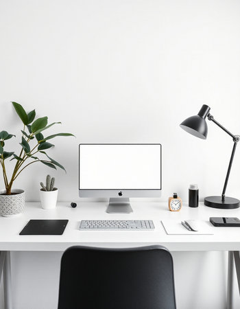workplace with blank screen computer, lamp, mobile phone and plant