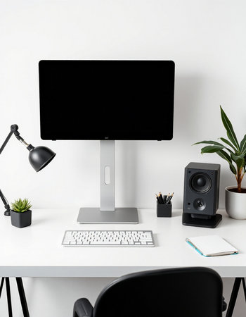 Workplace with computer, headphones and office supplies on white table.