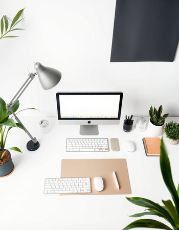 Top view of modern designer workplace with computer, keyboard, mouse, stationery and plants. Mock up