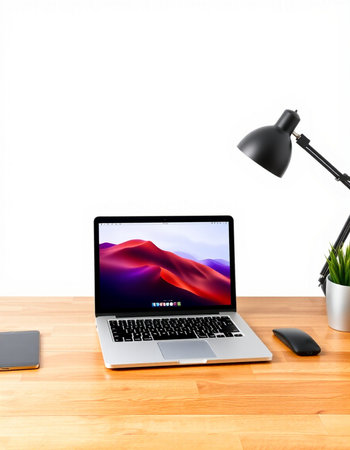 Workplace with laptop on wooden table and lamp on white background.