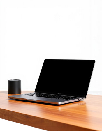 Laptop with black screen on wooden desk isolated on white background.
