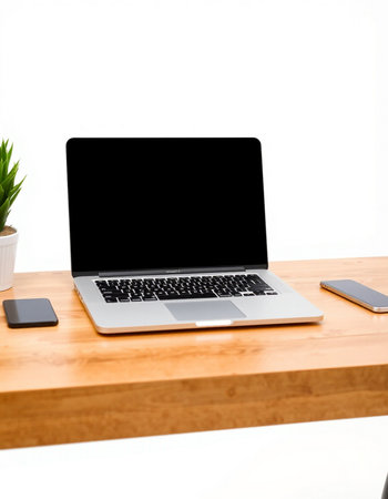 Laptop computer with blank screen on wooden table isolated on white background