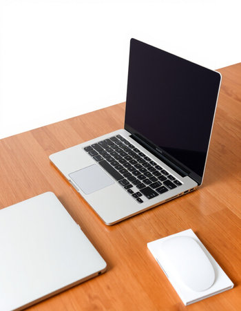 Laptop on a wooden table with a mouse and a white background