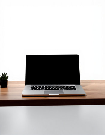 Laptop with blank screen on wooden desk isolated on white background.の写真素材