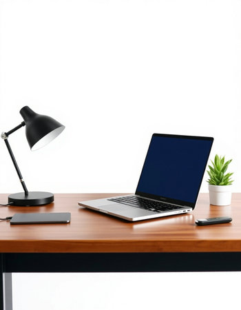 Laptop and lamp on wooden table isolated on white background. Workplaceの写真素材