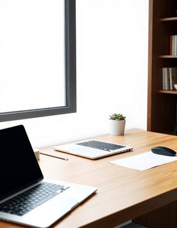 Laptop and office supplies on wooden table in office. Workplace concept