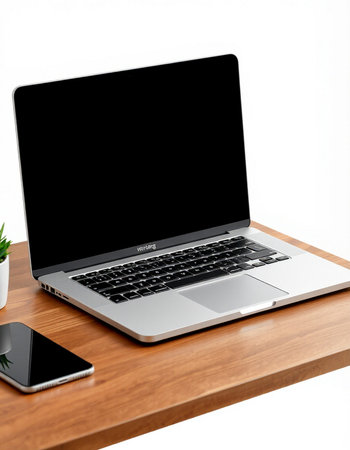 Laptop with blank screen on wooden table isolated on white background.