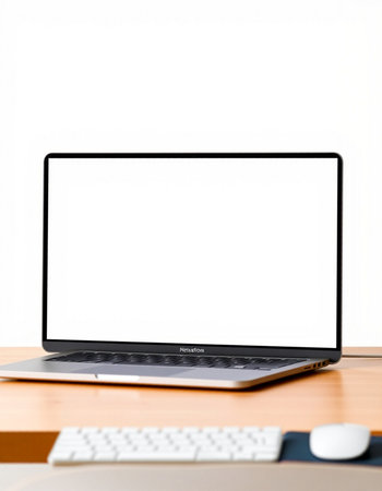 Laptop with blank screen on wooden table and white wall background.の写真素材