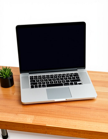 Laptop with blank screen on a wooden desk isolated on white background
