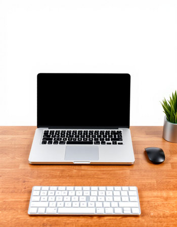 Laptop computer on wooden table with white wall background, stock photo