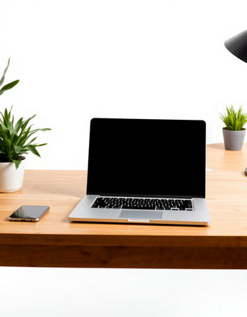 Laptop computer with blank screen on wooden desk isolated on white background