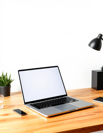 Modern workspace with blank screen laptop, coffee cup and other items on wooden table. Mock upの写真素材