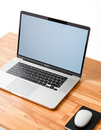 Laptop with blank screen on a wooden table with mouse and keyboard