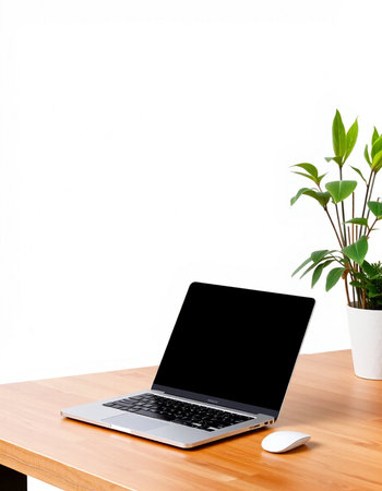 Laptop computer on wooden desk with white wall background, stock photo