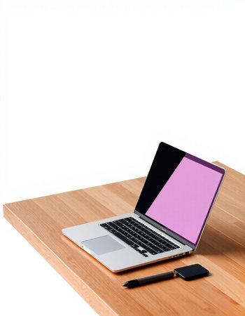 Laptop with blank screen and pen on wooden desk isolated on white background