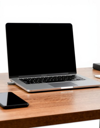 Laptop with blank screen on wooden table with smartphone and keyboard on white backgroundの写真素材
