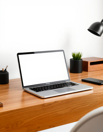 Laptop with blank screen on wooden table in office. Mockupの写真素材